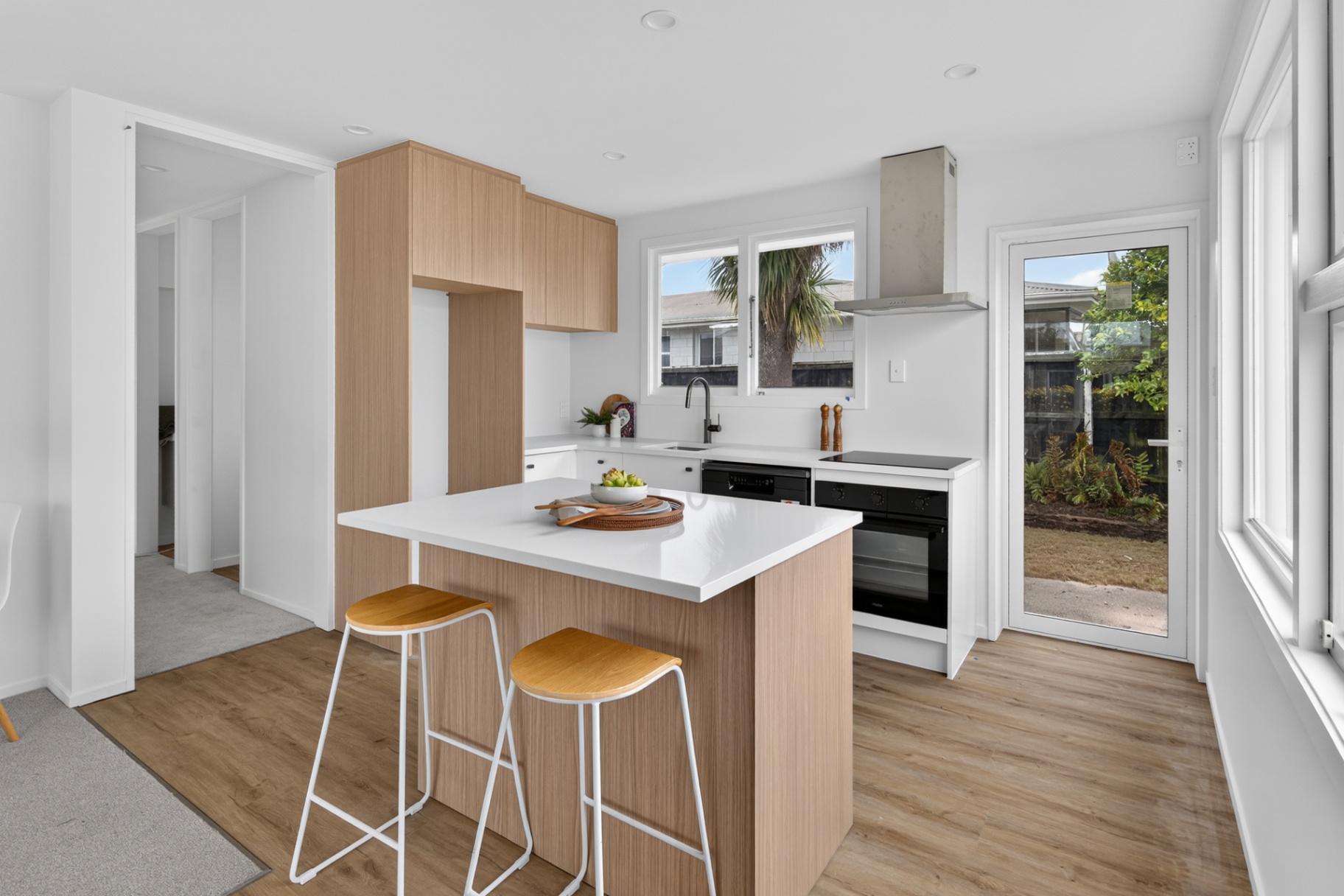 Kitchen with timber island and white finishes at 1A Quinns Road